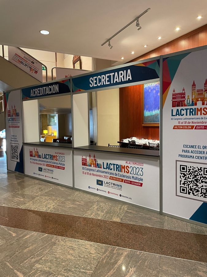 Branded accreditation and secretariat booths set up in a hotel lobby for a medical congress