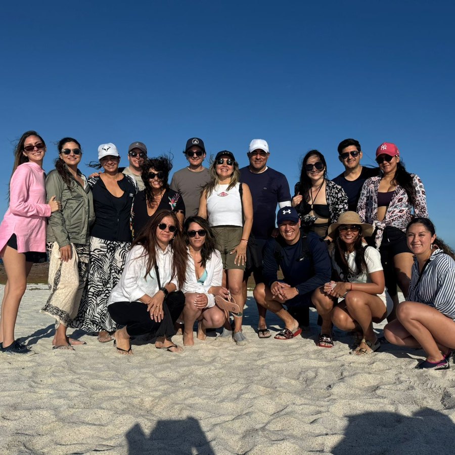 A corporate group together on a Galápagos beach