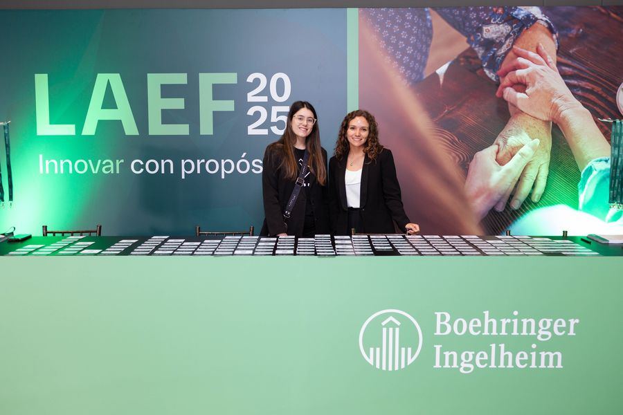 Registration desk staff ready with rows of attendee badges at a pharmaceutical congress