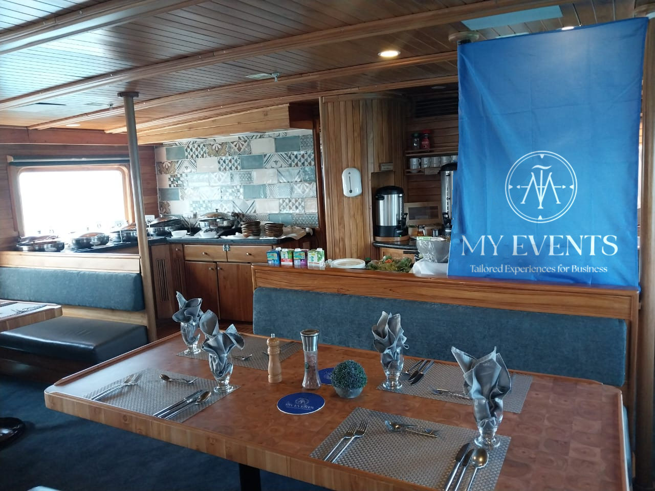 Yacht dining room set for an incentive group beneath a MY EVENTS banner