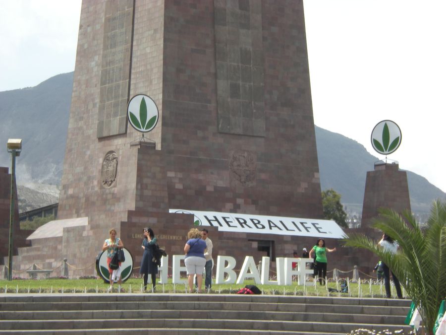 Company banners and branding displayed at the Middle of the World monument